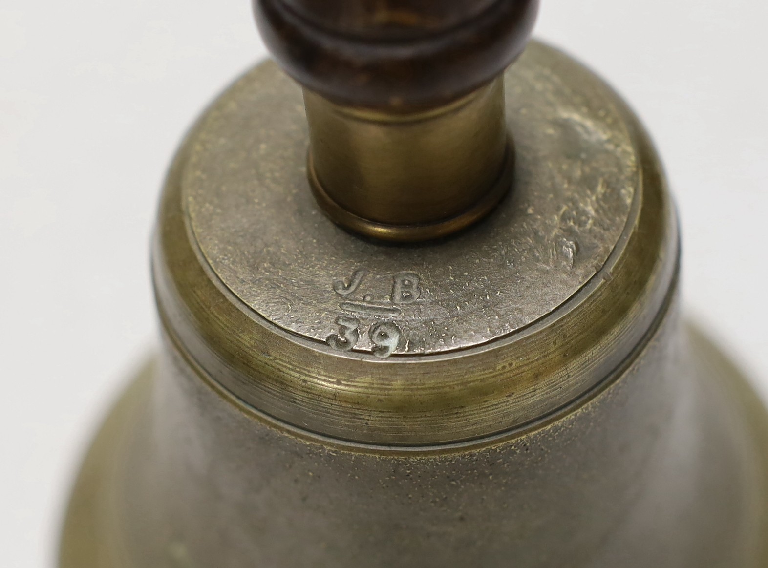 Two cannon balls, together with a brass hand bell marked A.R.P